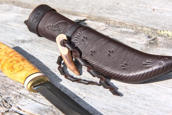 Knife with wooden handle and leather sheath