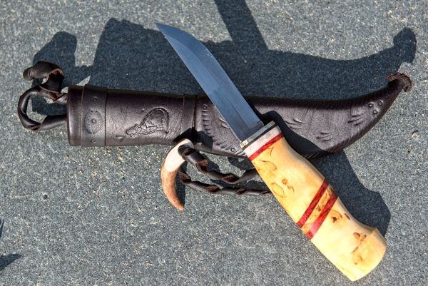Knife with wooden handle and leather sheath