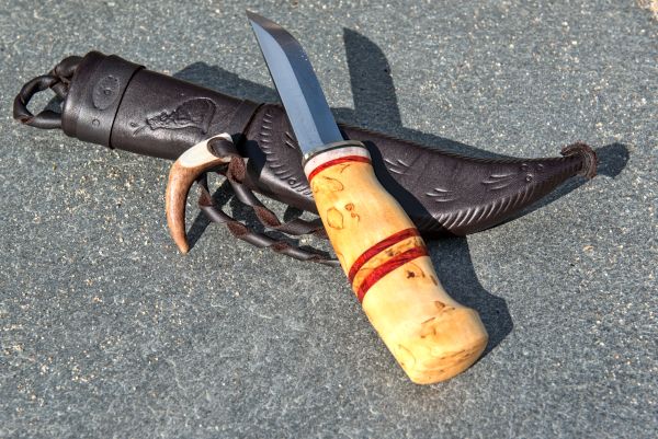Knife with wooden handle and leather sheath