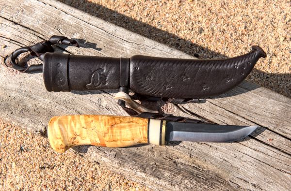 Knife with wooden handle and leather sheath