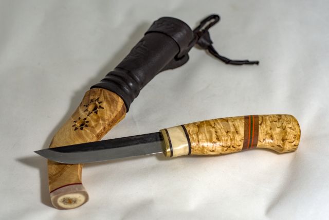 Knife with wooden handle and sheath made from wood and leather